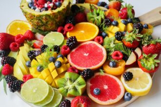 A vibrant assortment of fresh fruits beautifully arranged on a platter, perfect for a healthy and delicious snack.